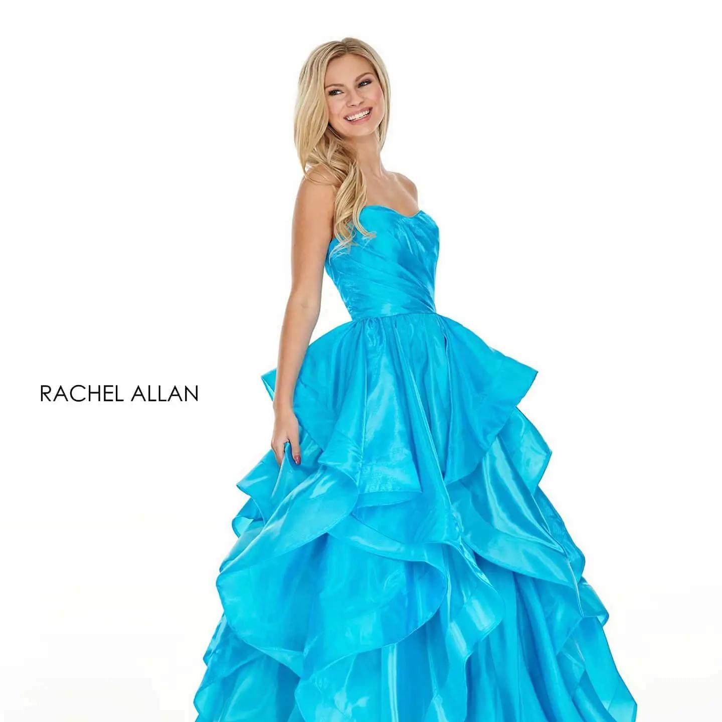 Model wearing a blue gown. Mobile image
